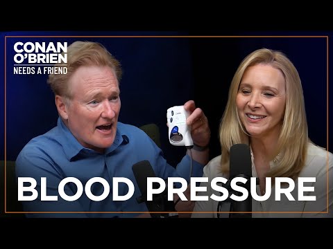 Conan Shows Off His Blood Pressure Monitor (Feat. Lisa Kudrow) | Conan O’Brien Needs A Friend [Video]